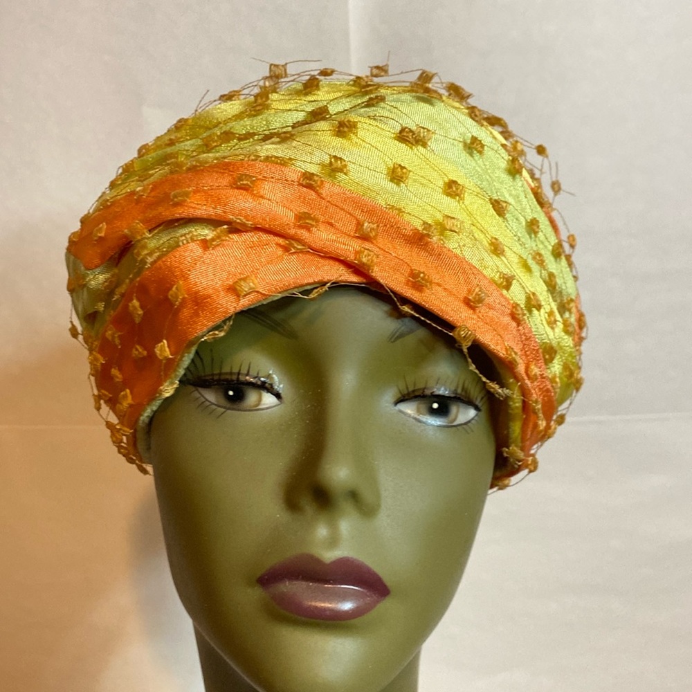 Vintage pillbox hat from the 1940s, yellow and orange with lace around hat